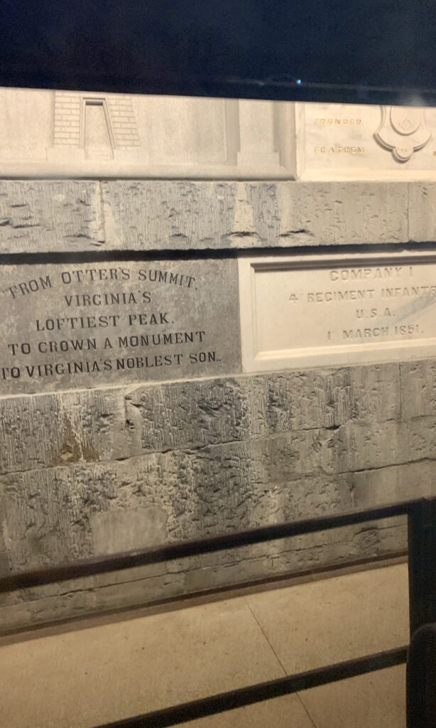 stone wall inside an elevator with words written on them