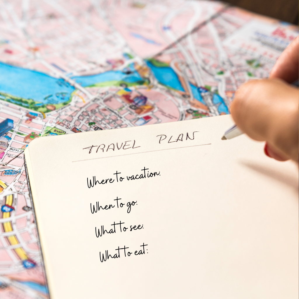 A piece of paper with words on it on top of a street map. a woman's fingers holding a pen