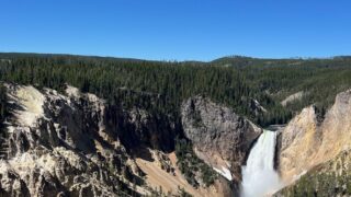 A waterfall in the distance of a valley