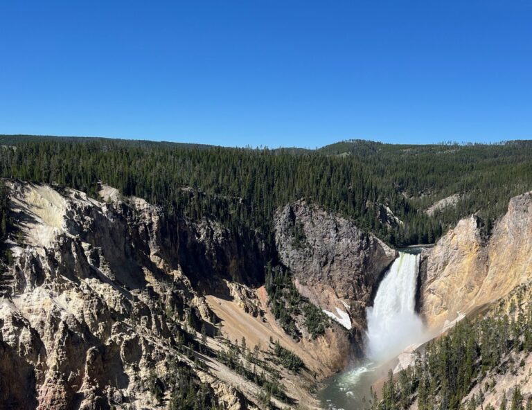 A waterfall in the distance of a valley